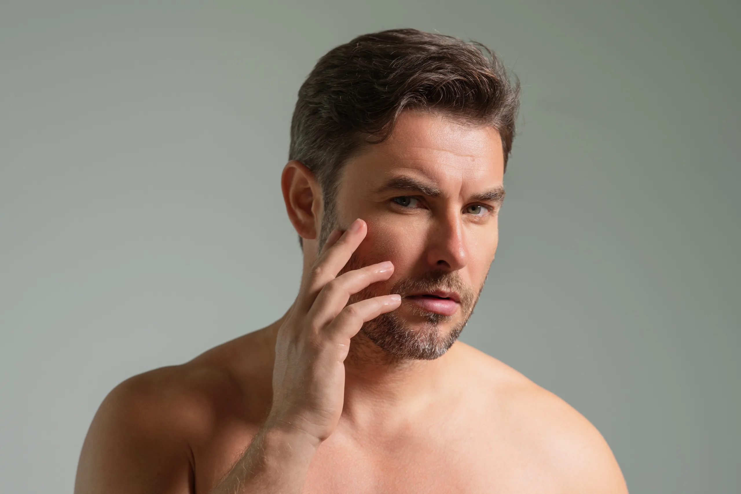 Man touching his face and looking concerned about a skin infection