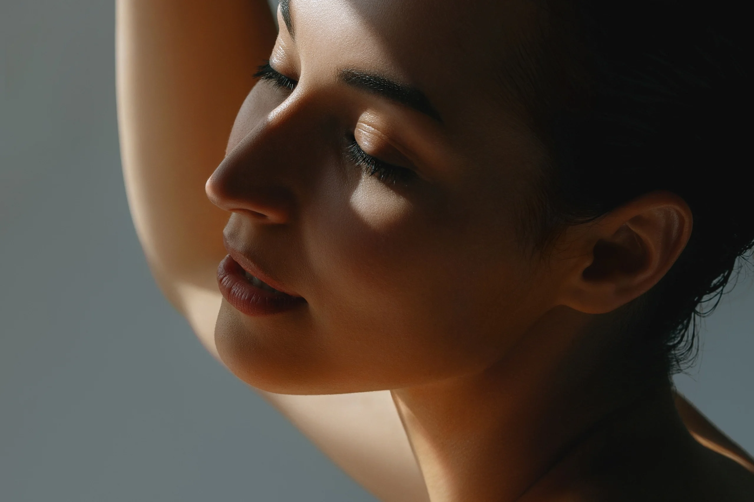Profile of a woman's face and neck in soft lighting