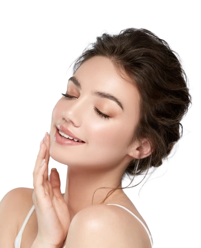 Woman with dark hair touching her face and smiling with eyes closed against white background