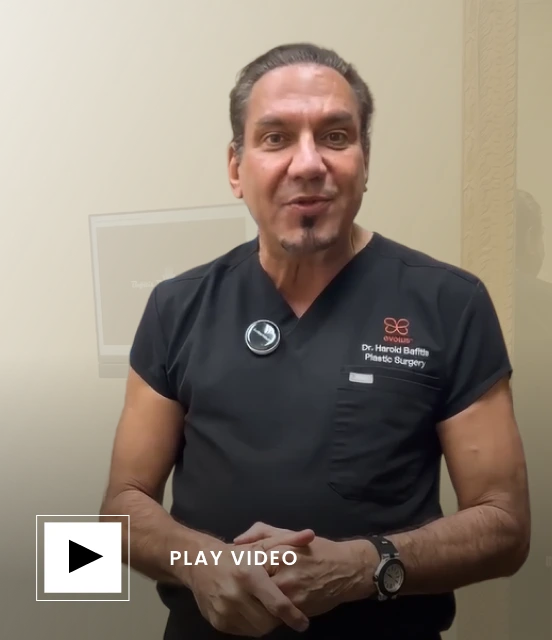 Dr. Harold Baffitis in surgical attire at his practice, play video button
