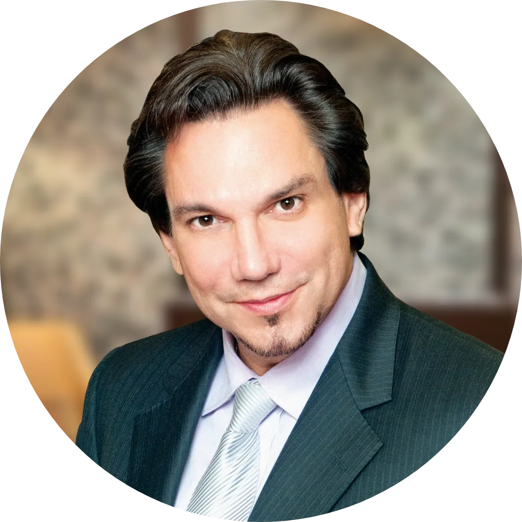 Dr. Bafitis in dark suit and light blue striped tie, professional headshot