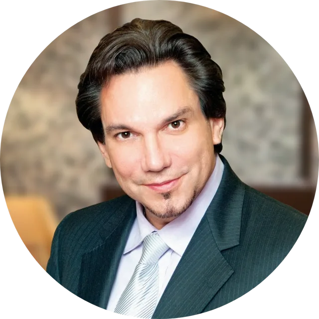 Dr. Bafitis in dark suit and light blue striped tie, professional headshot