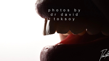 Back of a person's head and neck in profile against a light background