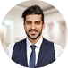 Man in navy blazer and tie, professional headshot