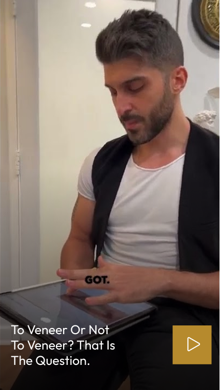 Man in dental office reviewing information about veneers on a tablet