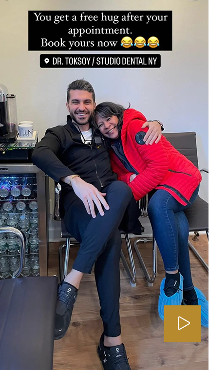 Patient and dentist hugging in office with text 'You get a free hug after your appointment. Book yours now' and 'DR. TOKSOY / STUDIO DENTAL NY'