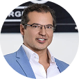 Smiling man wearing glasses and blue shirt