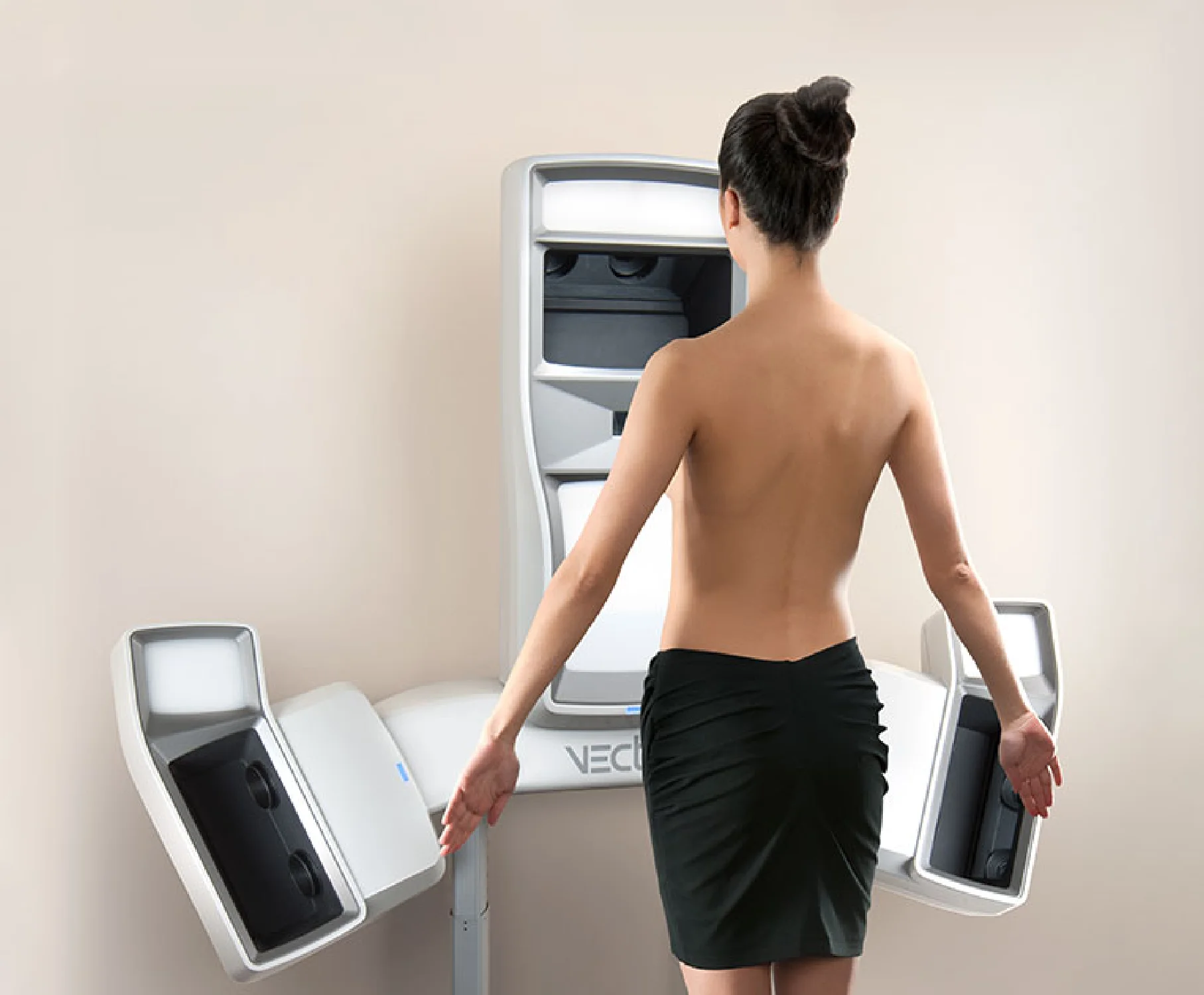 Woman standing before 3D body imaging system with multiple scanning cameras