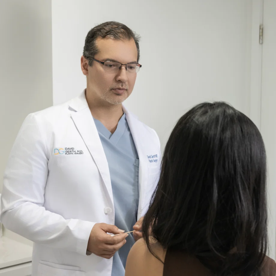 Doctor in white coat consulting with female patient about injectable treatment