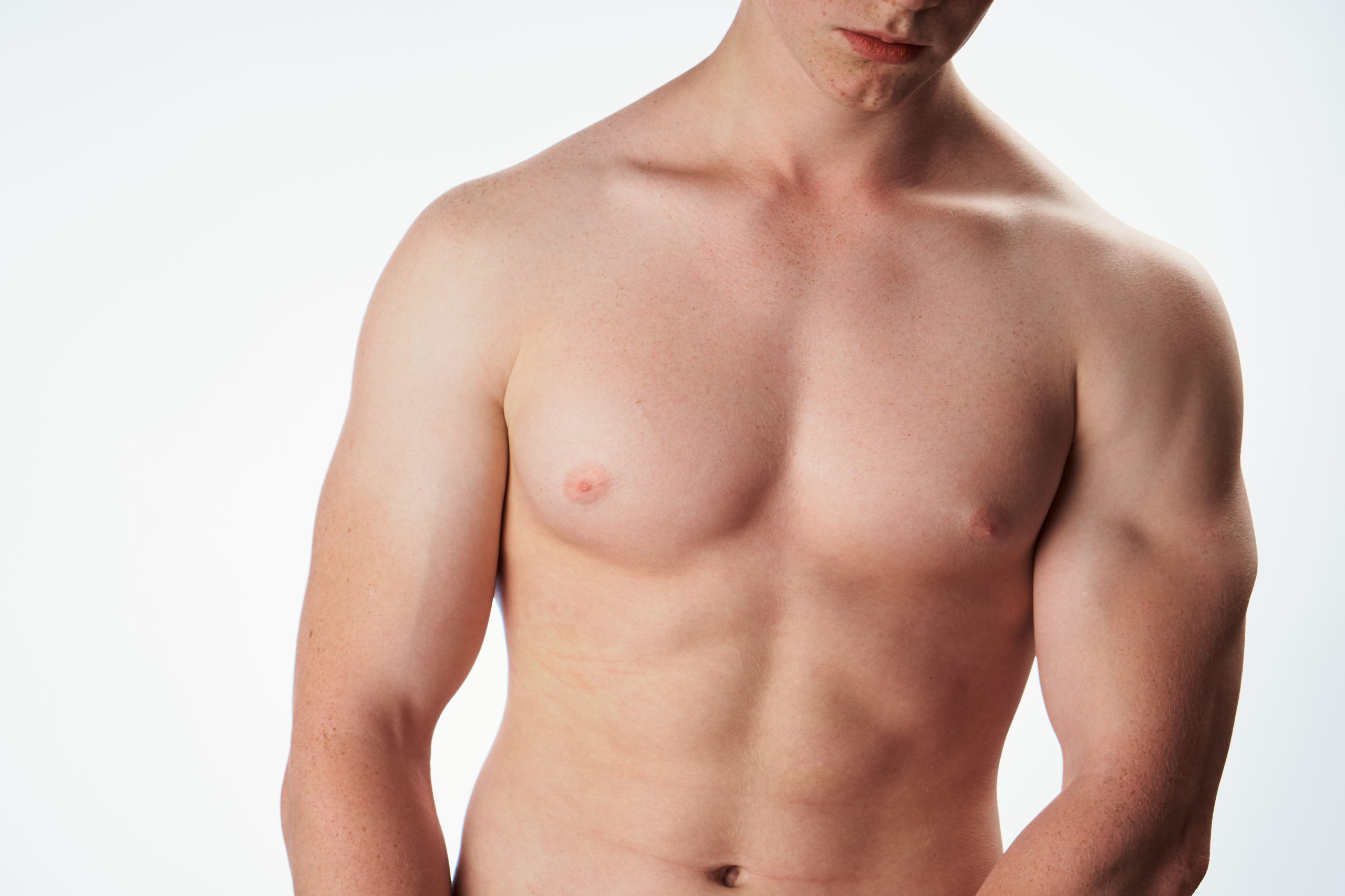 Shirtless man displaying defined abdominal and chest muscles against a white background