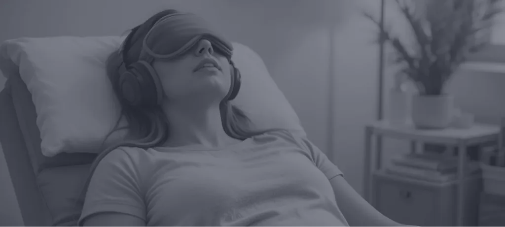Person wearing headphones reclined on pillow in calm interior setting