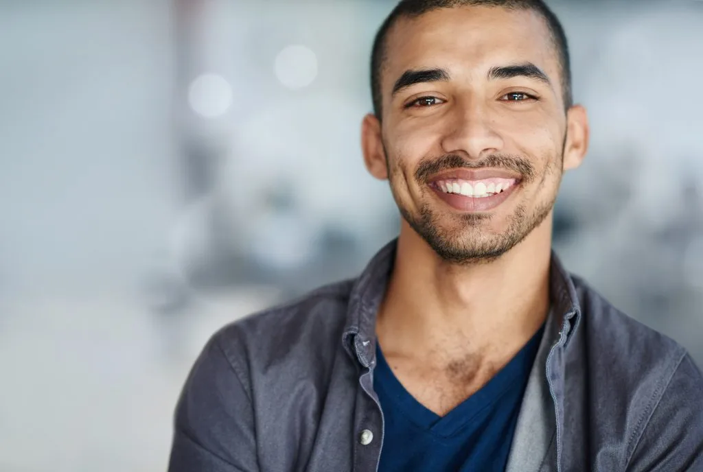 Man smiling at camera in office setting