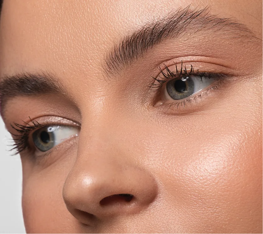 Close-up of woman's eyes showing tinted dark lashes and defined brows