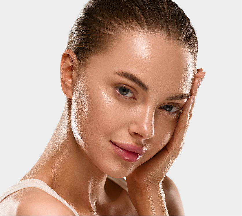 Woman with glowing, hydrated skin touching her face