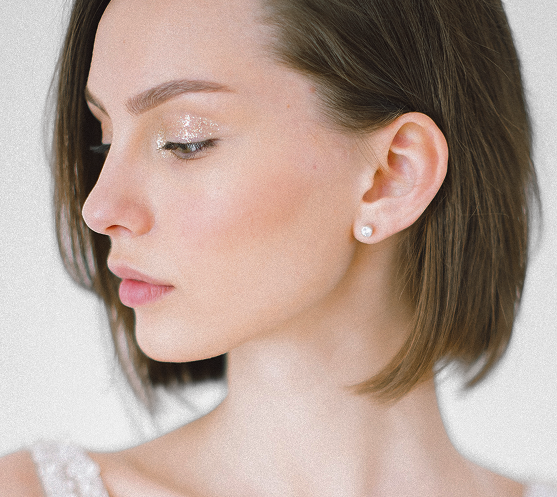 Woman in profile with hand near ear showing ear aesthetic after otoplasty