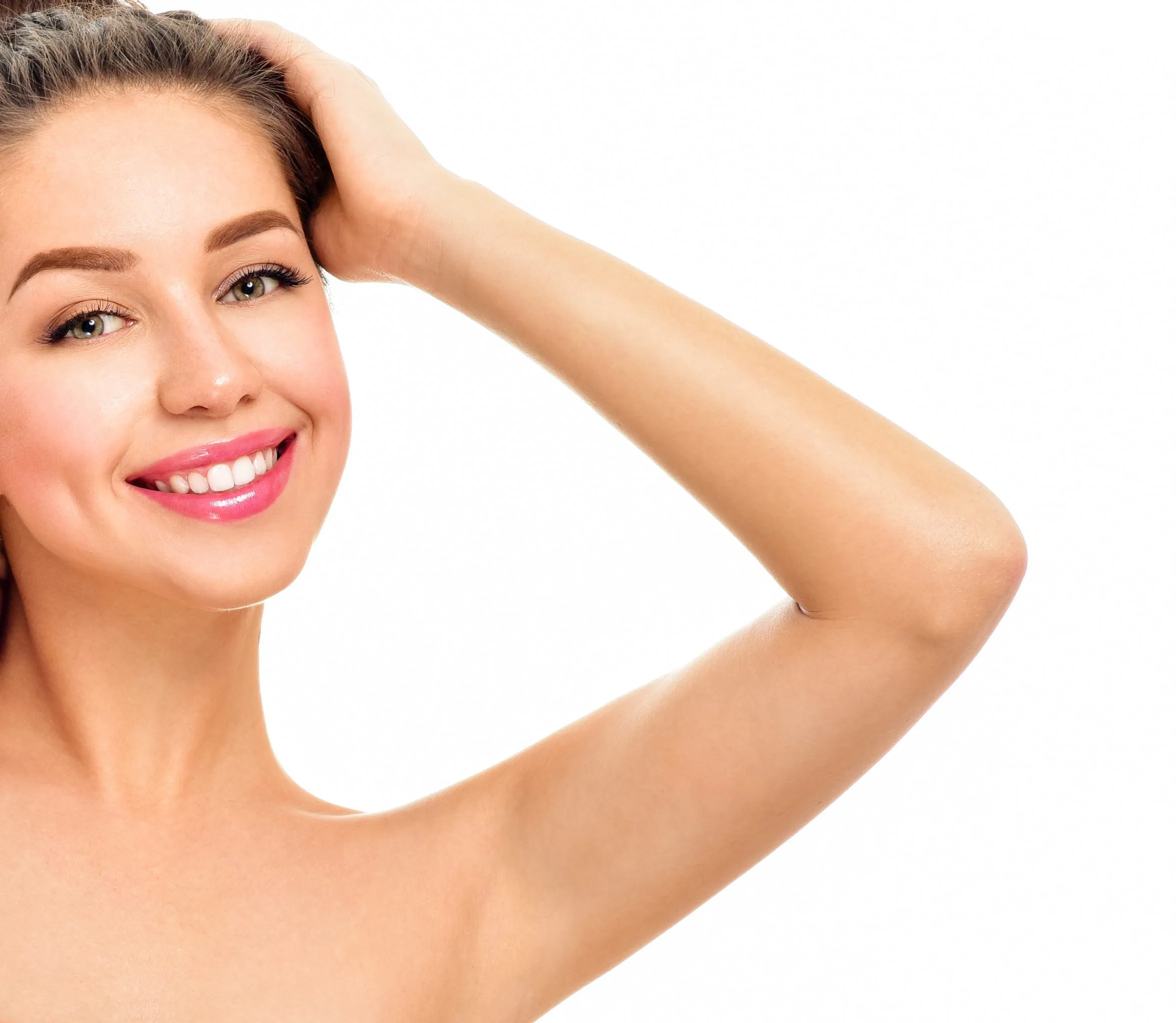 Woman smiling with hand raised to head, displaying skin and complexion
