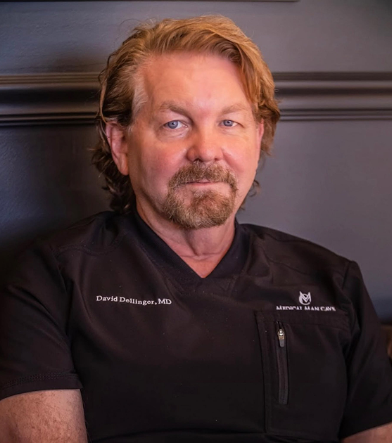 David Dellinger, MD in black medical scrubs with practice logo