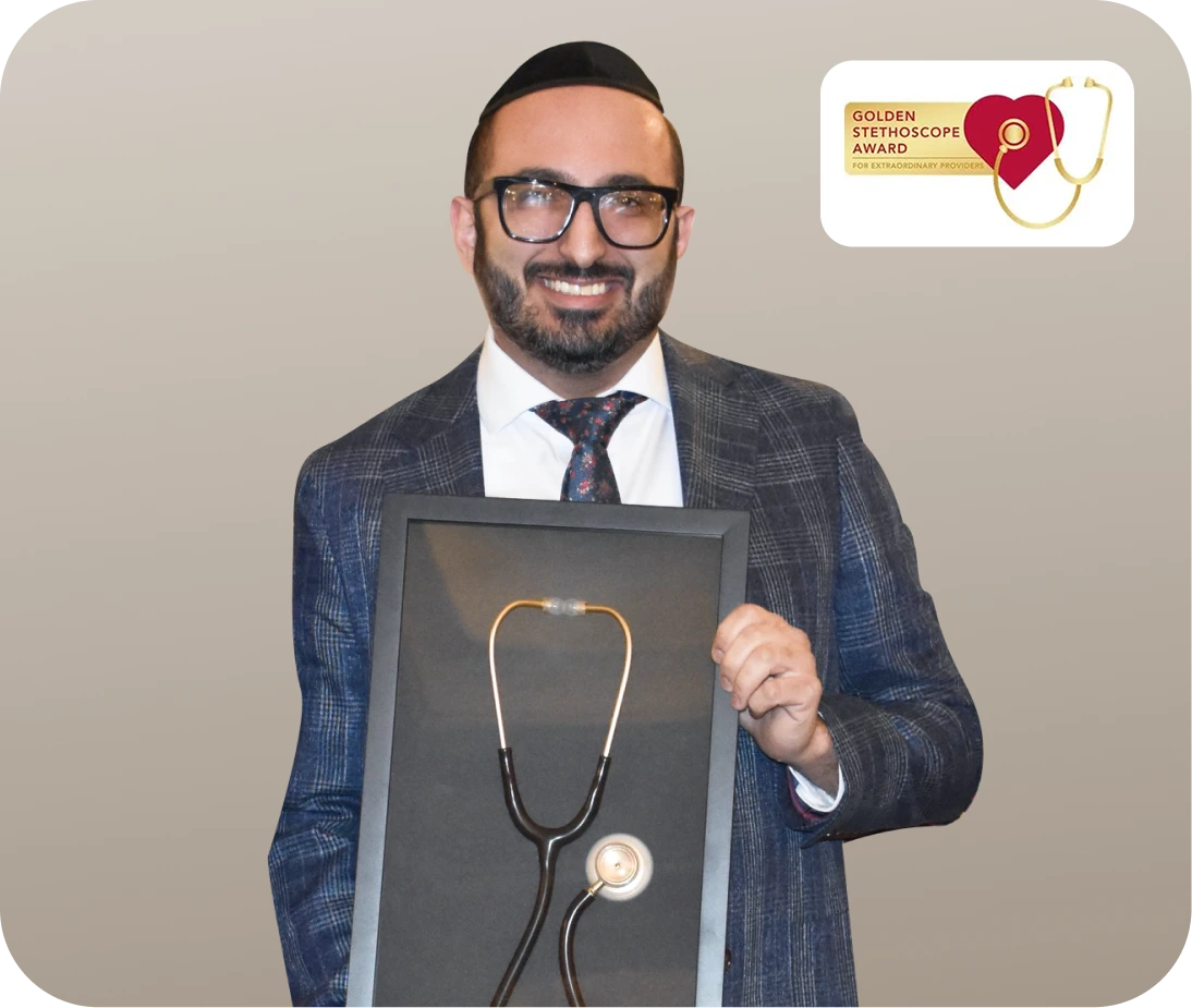 Physician in suit holding framed stethoscope with Golden Stethoscope Award badge