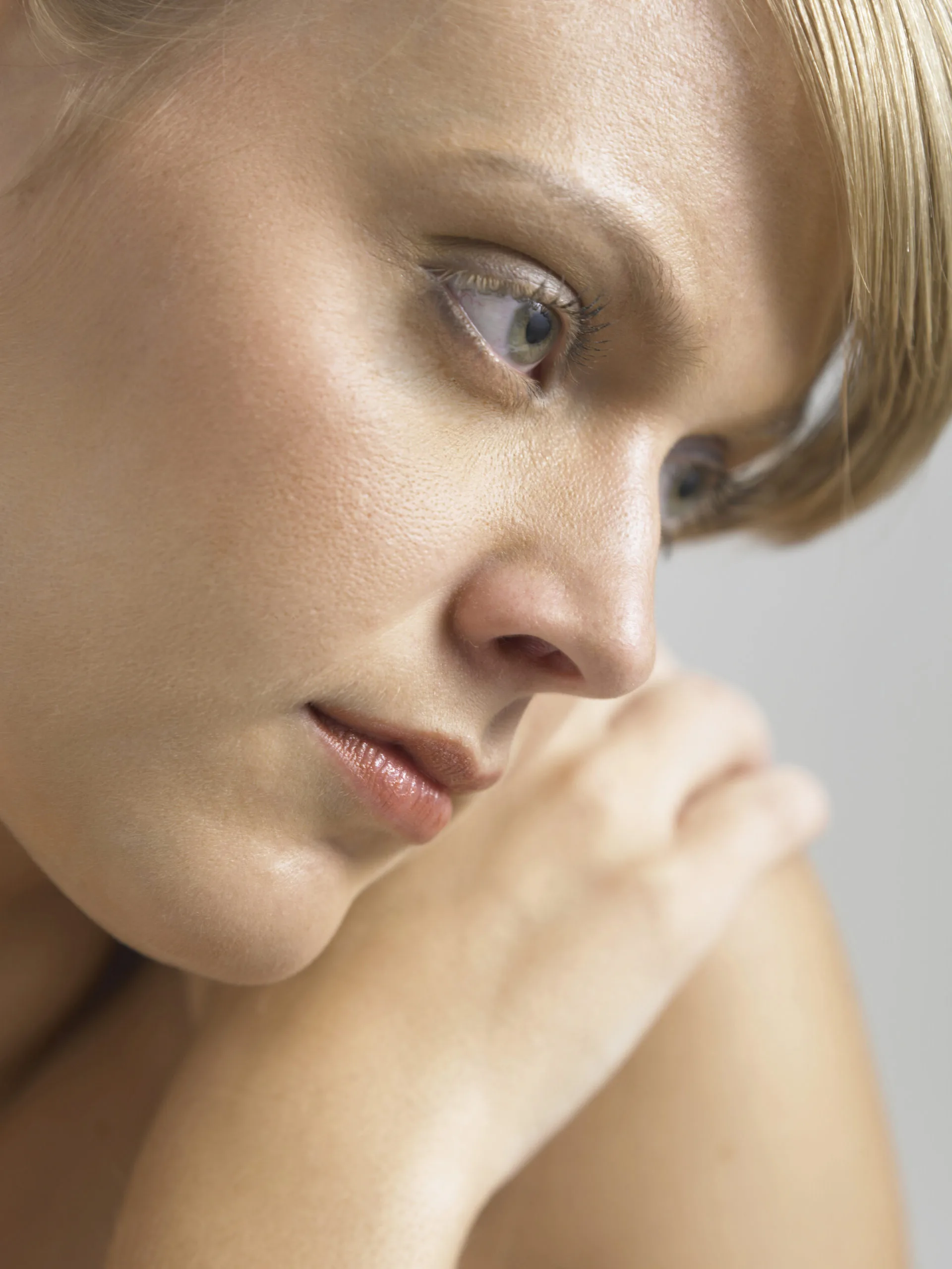 Woman's profile showing clear, glowing skin against a white background