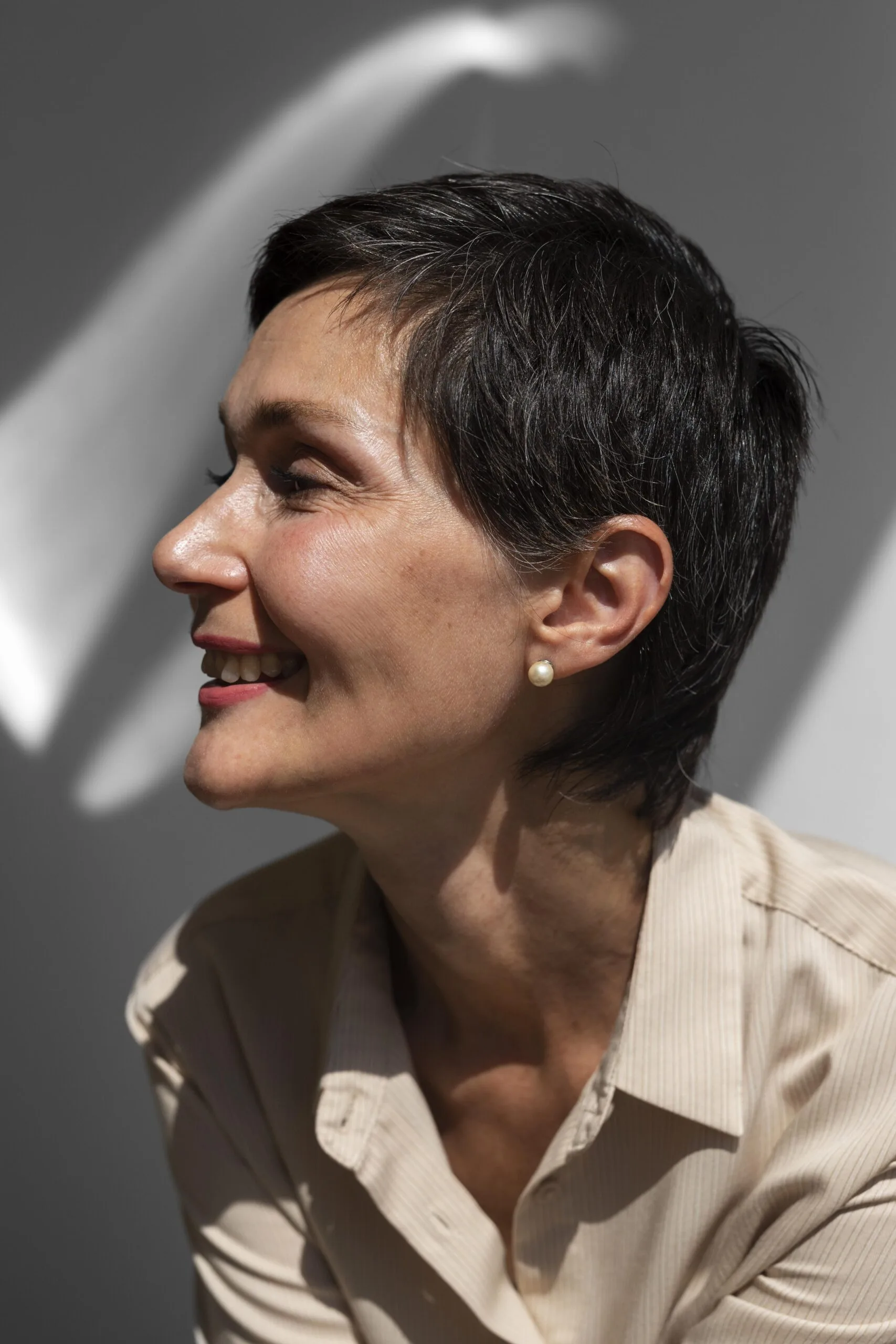 Woman with restored hair shown in profile, smiling