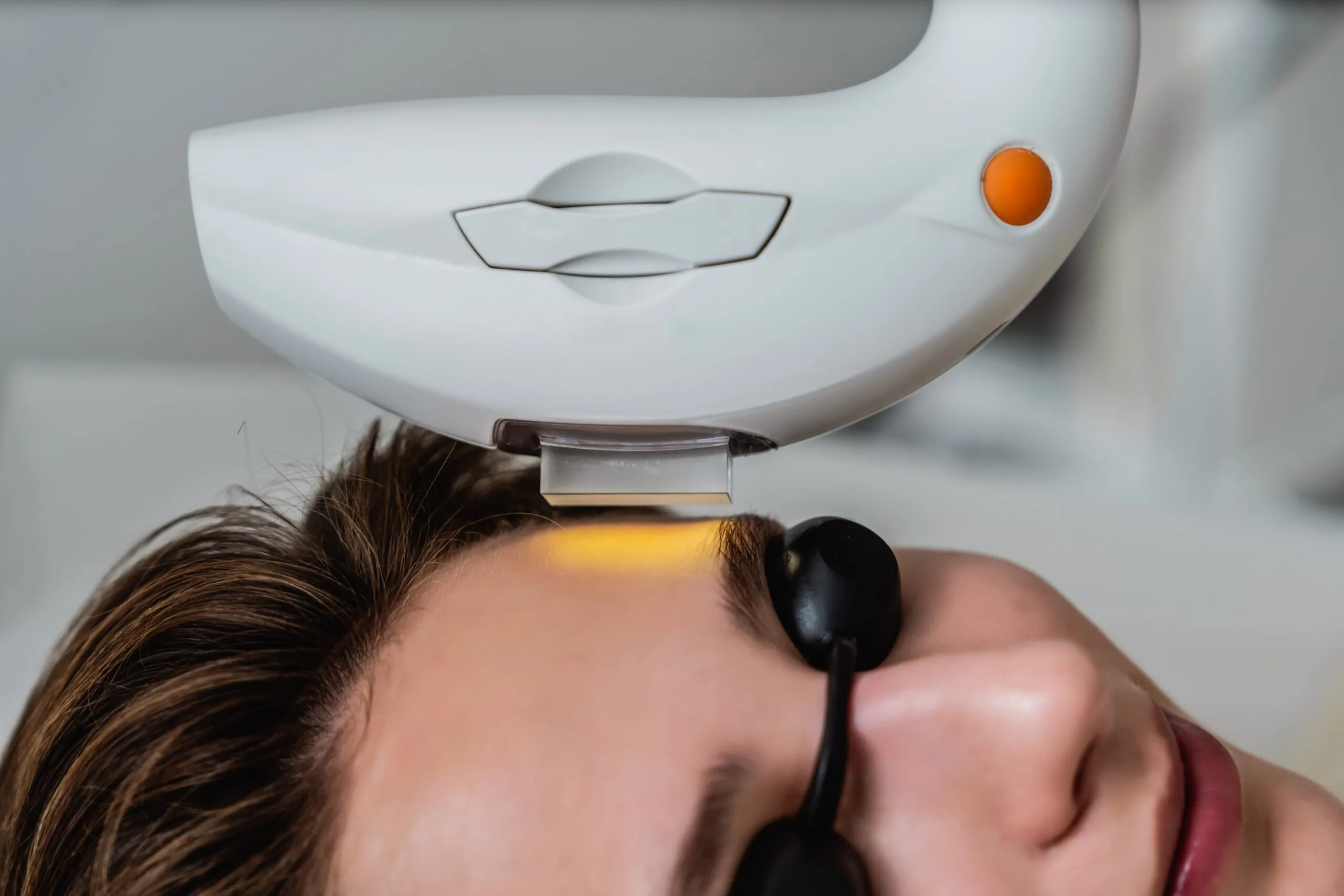 IPL device delivering light therapy treatment to a patient's forehead