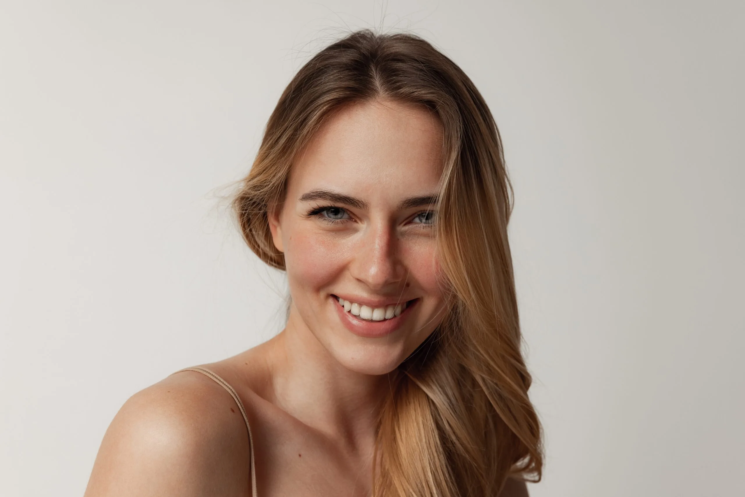 Woman with smooth, radiant skin smiling at camera