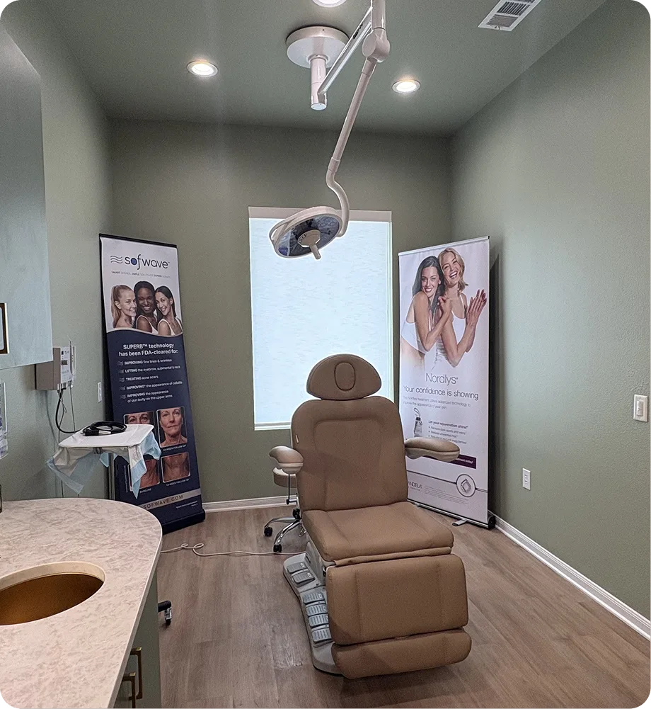 Treatment room with brown leather patient chair, overhead surgical light, and Sofwave and Nordlys device banners on walls
