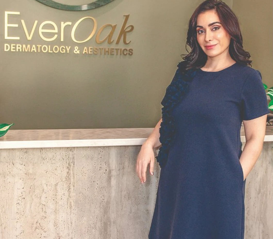 Dr. Mahsa Karavan at the EverOak Dermatology front desk in Celina, TX, featured in Living Magazine Top Healthcare 2026
