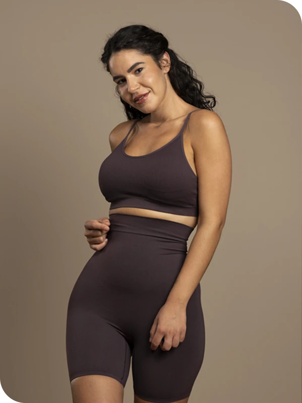 Woman in fitted athletic wear showing body confidence and posture