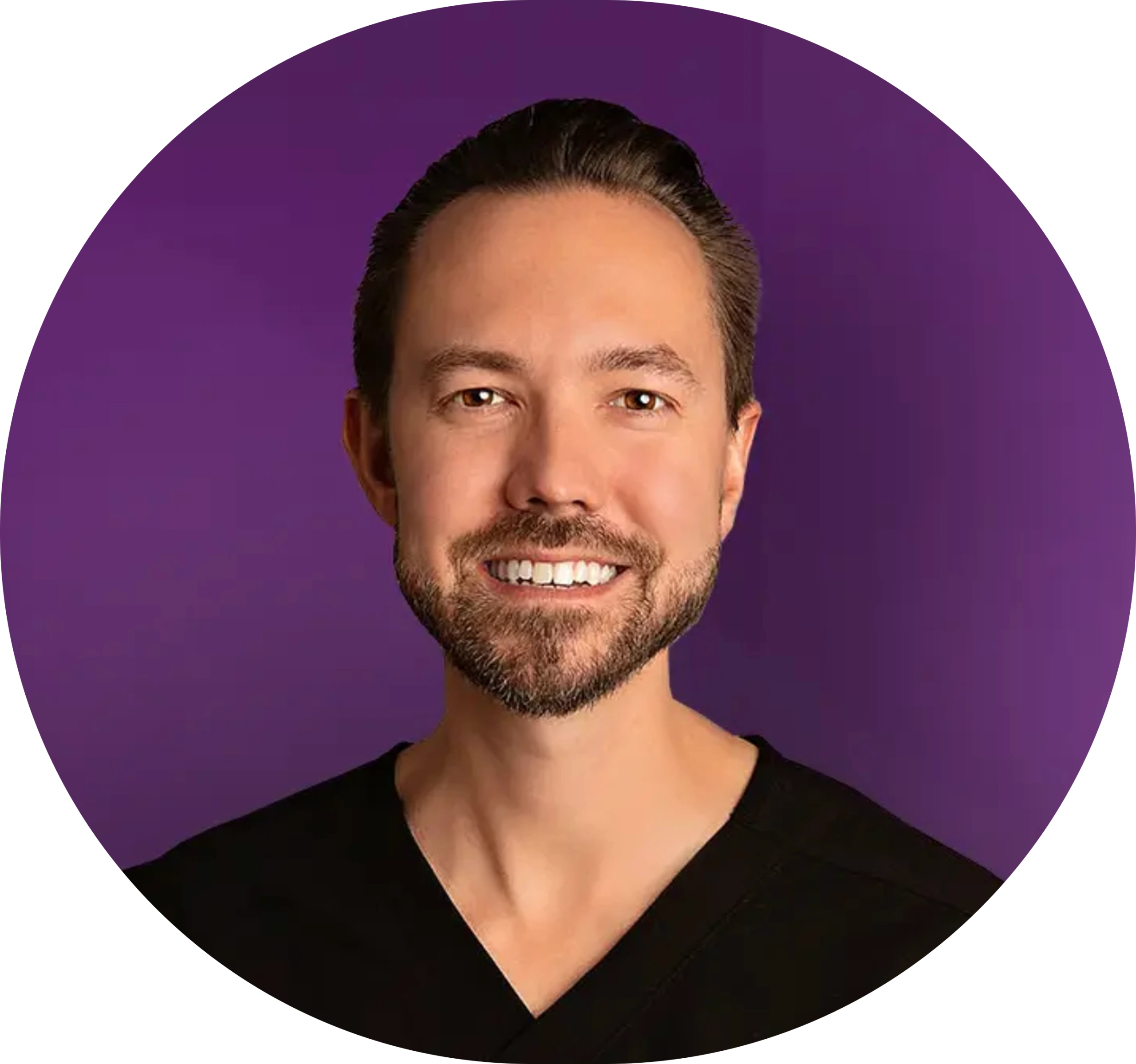 Man with beard smiling in circular portrait against purple background