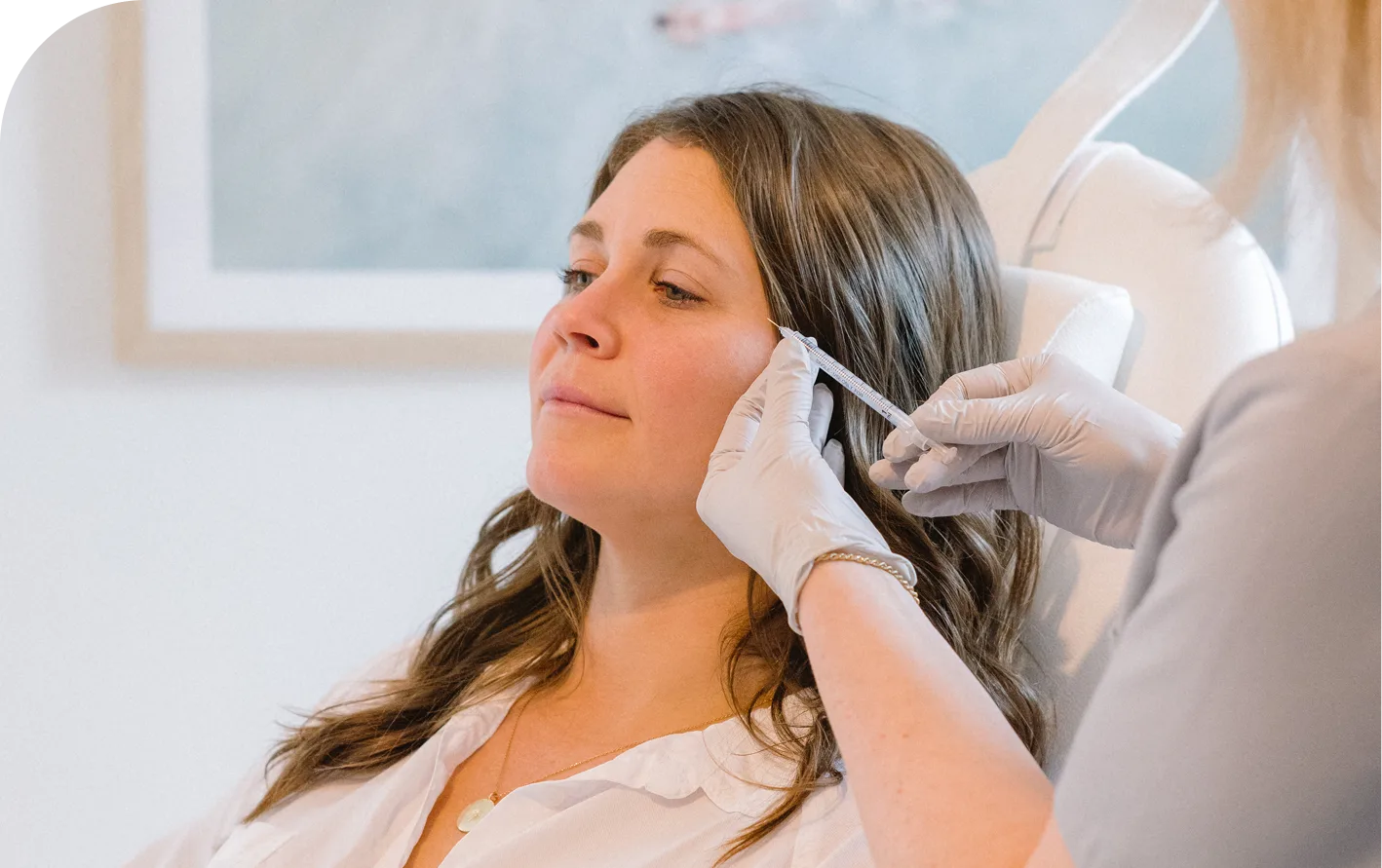 Practitioner marking patient's face with pen during Dysport consultation