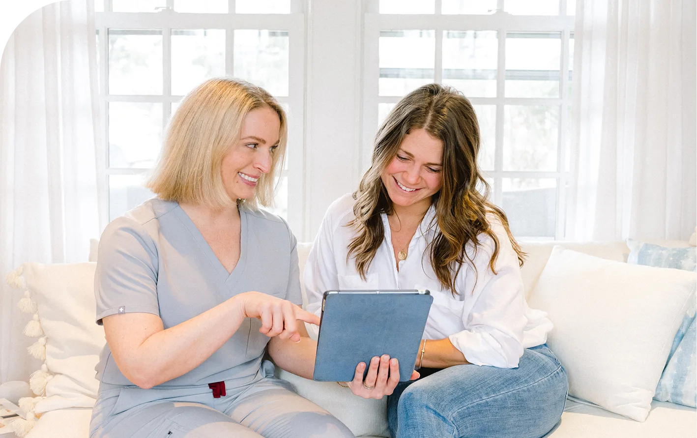 Practitioner and patient reviewing filler correction results on tablet together