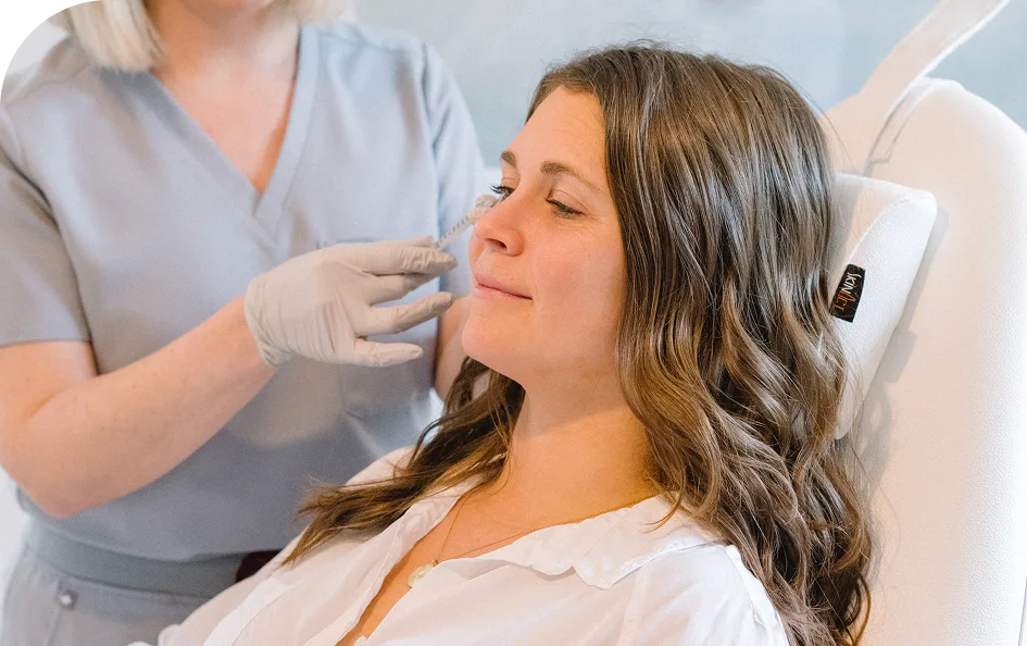 Provider administers Sculptra injection to patient's cheek area