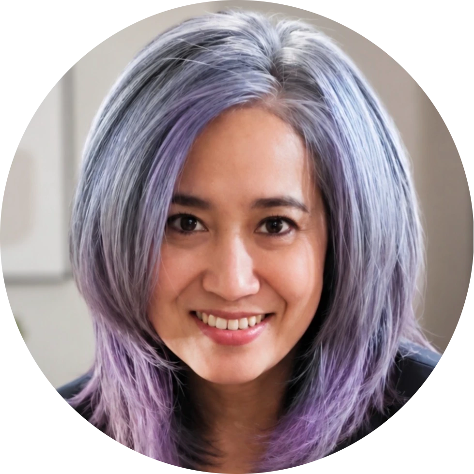 Team member with purple-tinted hair smiling at camera