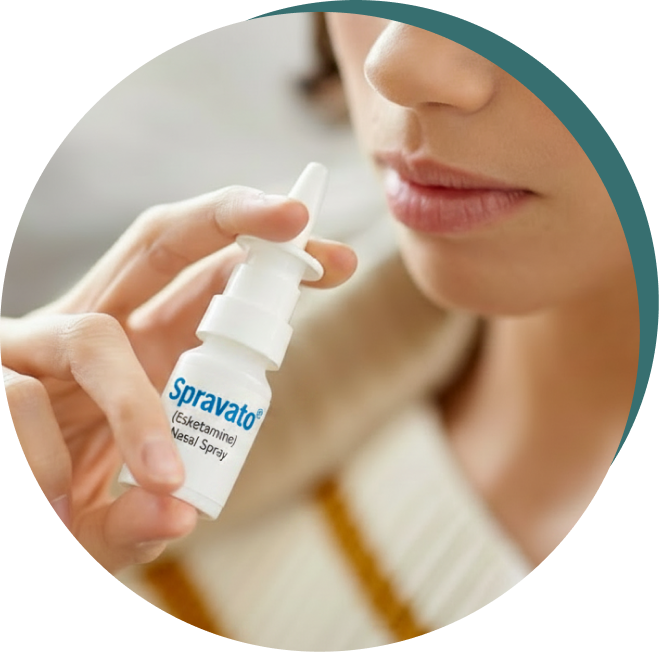 Woman holding Spravato nasal spray bottle near her face for medication administration