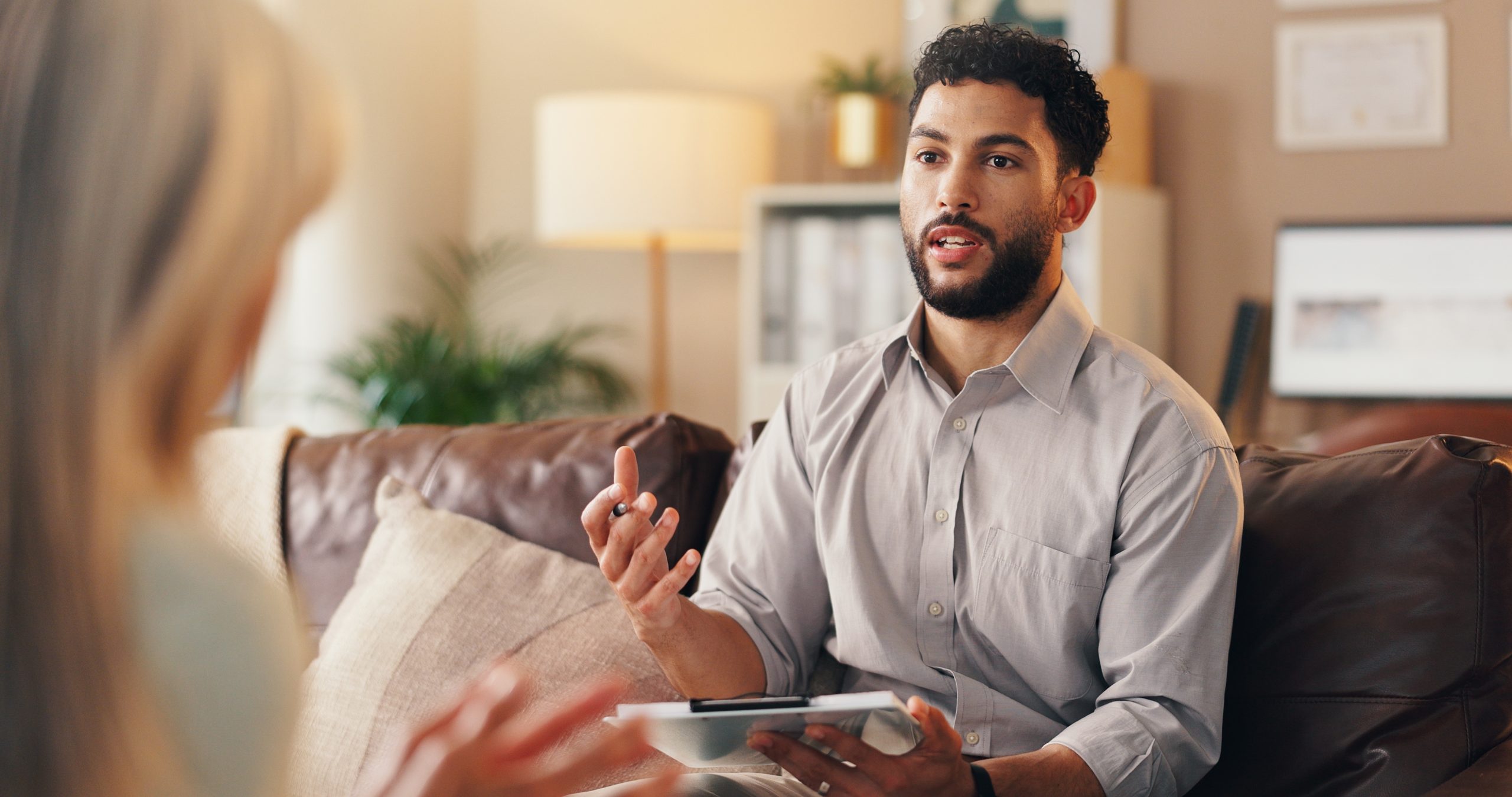Therapist speaking with patient during consultation in wellness office