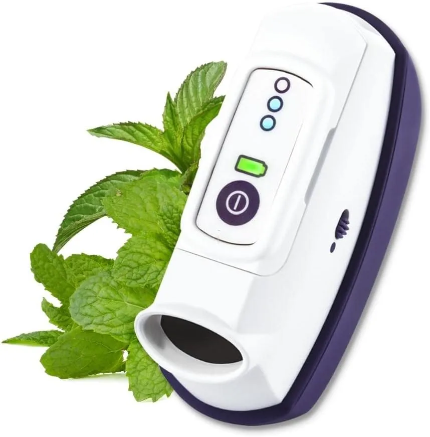 Handheld pain relief device with white and purple casing next to fresh mint leaves