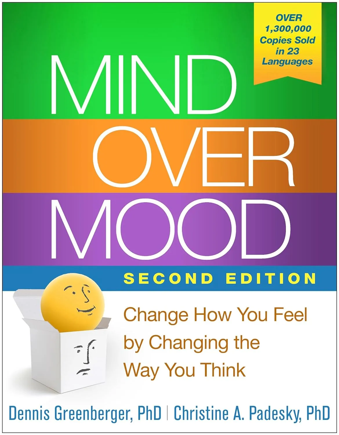 Mind Over Mood Second Edition book cover by Dennis Greenberger and Christine A. Padesky, featuring yellow smiley face in white box