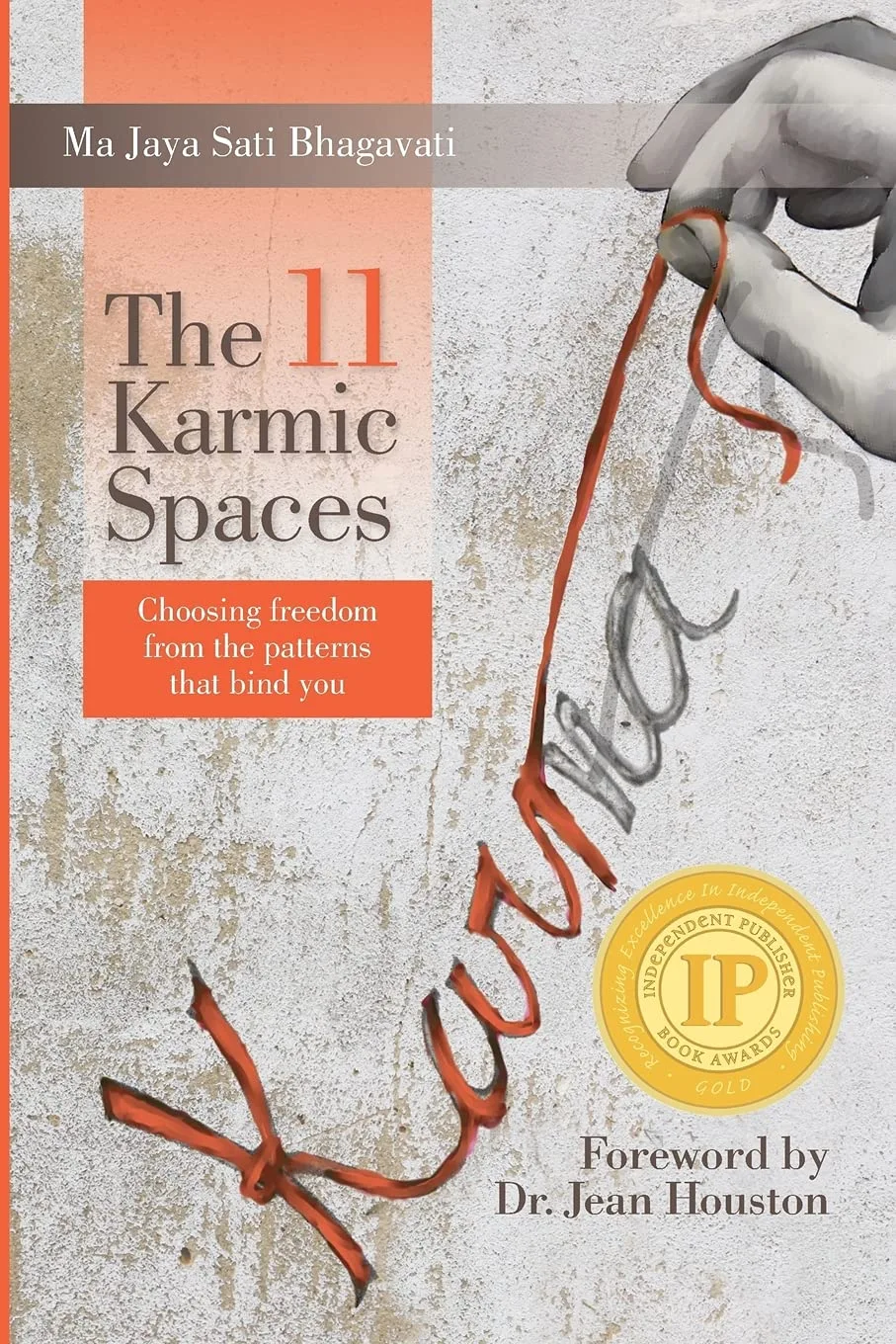The 11 Karmic Spaces book cover by Ma Jaya Sati Bhagavati with hand holding red thread, Independent Publisher Book Award gold seal