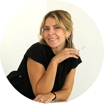 Woman in black shirt smiling at camera, professional portrait