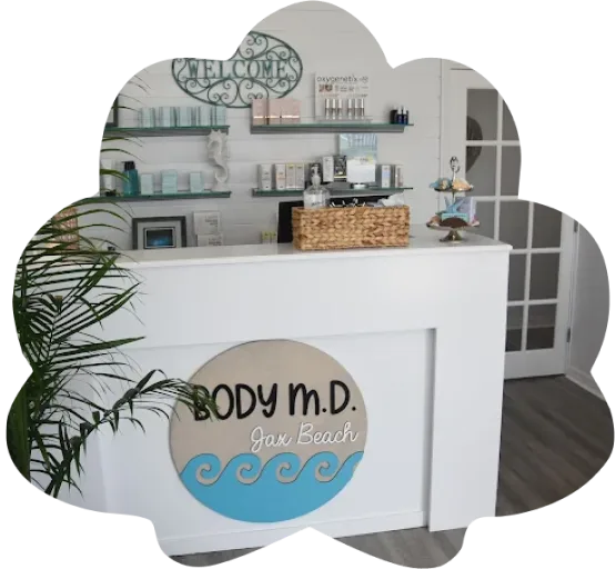 Body M.D. Jax Beach reception desk with welcome sign, product shelves, and palm plant