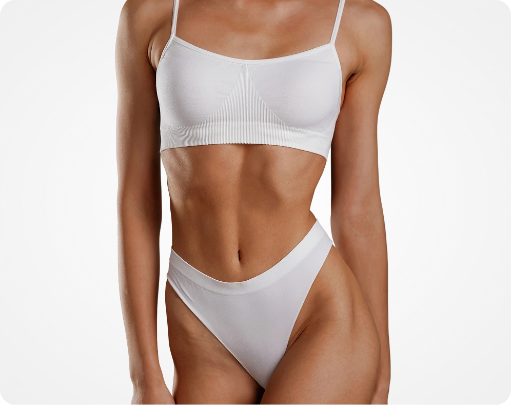 Woman displaying toned abdominal muscles in white bikini