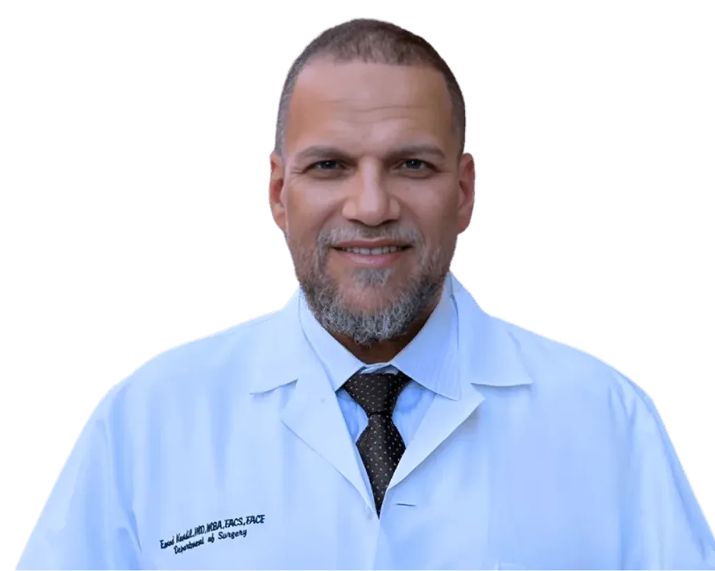 Dr. Emad Kandil in light blue medical coat with dark tie, portrait against white background