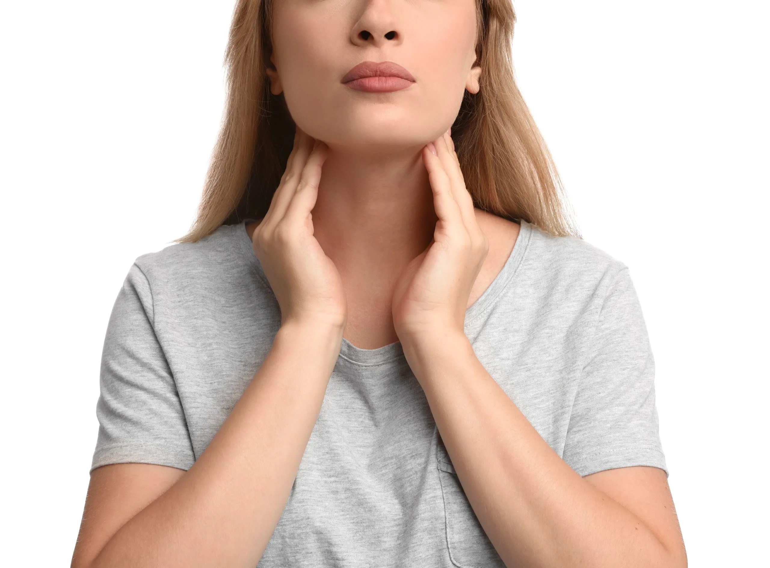 Woman performing self-examination of thyroid gland on neck