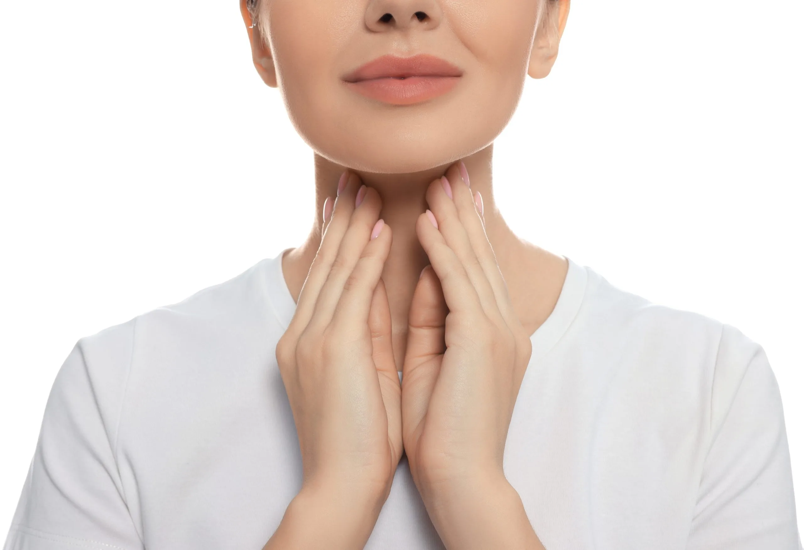 Woman performing thyroid self-examination by palpating her neck with both hands
