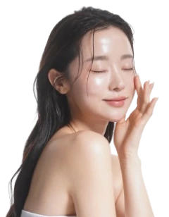 Woman touching her cheek with closed eyes and glowing skin