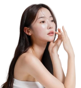 Woman with long dark hair touching her face, showcasing clear skin