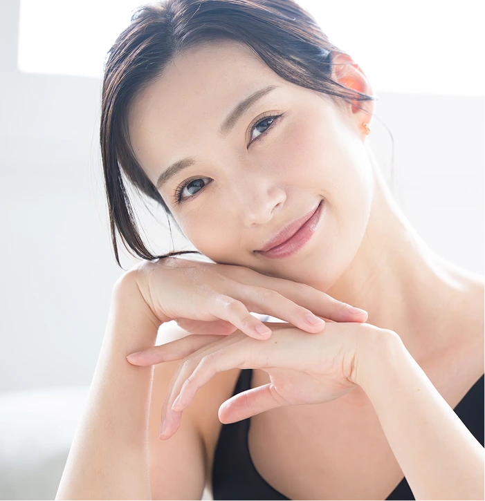 Woman with smooth, glowing skin displaying results after dermaplaning treatment