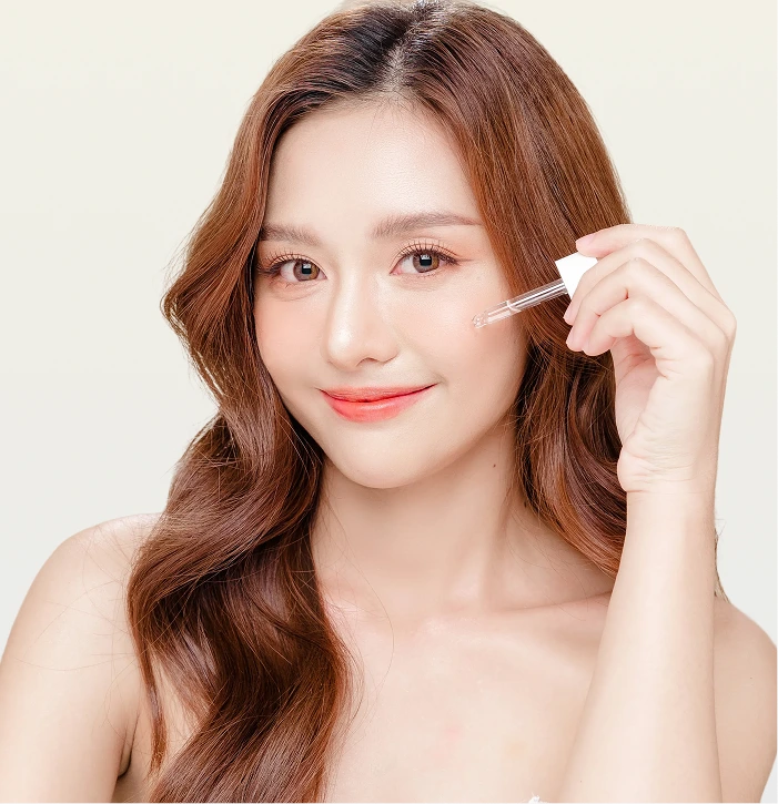 Woman applying serum with dropper near eye area during Cell RX treatment