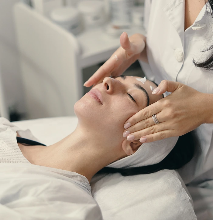 Esthetician performing glass skin facial treatment on client at spa